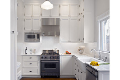 Small traditional l-shaped separate kitchen in San Francisco with a farmhouse sink, recessed-panel cabinets, white cabinets, marble benchtops, white splashback, ceramic splashback, stainless steel appliances, dark hardwood floors and no island.