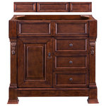 James Martin Vanities - Brookfield 36" Warm Cherry Single Vanity - The Brookfield 36" Warm Cherry vanity by James Martin Vanities features hand carved accenting filigrees and raised panel doors. One door opens to shelves for storage below and two drawers, made up of a lower double-height drawer and a middle standard drawer, offer additional storage space. The look is completed with Antique Brass finish door and drawer pulls. Matching decorative wood backsplash is included.
