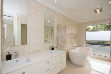 Contemporary bathroom in Brisbane with white cabinets and a freestanding tub.