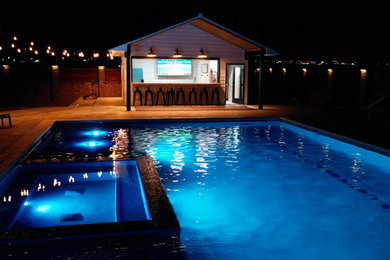 Large backyard rectangular natural pool house photo in Denver
