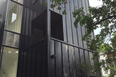 Trendy black metal exterior home photo in Toronto
