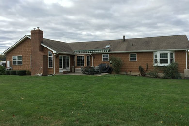 Example of a classic brown one-story wood exterior home design in Baltimore