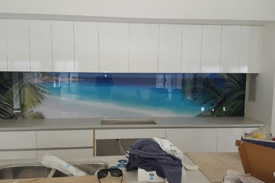 Design ideas for a large modern single-wall kitchen in Brisbane with glass sheet splashback.