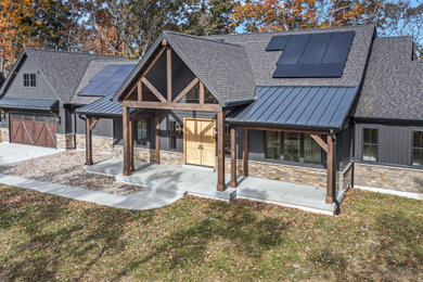 Inspiration for a large country gray one-story metal and board and batten exterior home remodel in St Louis with a mixed material roof and a black roof