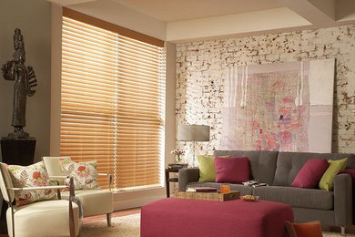 Example of an eclectic medium tone wood floor living room design in San Diego with beige walls