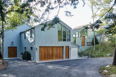 Example of a large trendy two-story wood house exterior design in Other with a shingle roof