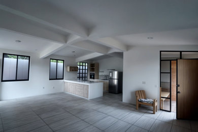 Mid-sized mountain style open concept ceramic tile and beige floor living room photo in Other with white walls