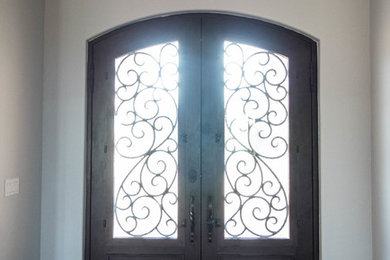 Mid-sized mountain style dark wood floor entryway photo in Oklahoma City with white walls and a dark wood front door