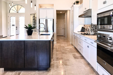 Kitchen - large contemporary single-wall travertine floor and beige floor kitchen idea in Orlando with an undermount sink, shaker cabinets, white cabinets, marble countertops, multicolored backsplash, mosaic tile backsplash, stainless steel appliances, an island and white countertops