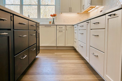 Inspiration for a large transitional u-shaped vinyl floor and brown floor kitchen pantry remodel in Other with an undermount sink, shaker cabinets, white cabinets, quartz countertops, white backsplash, porcelain backsplash, stainless steel appliances, an island and white countertops