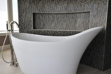 Example of a large transitional master limestone floor and white floor freestanding bathtub design in Other with beige walls
