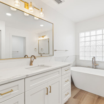 Warm Transitional Two-Room Primary Bathroom