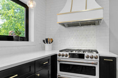 Eat-in kitchen - small transitional galley ceramic tile and black floor eat-in kitchen idea in DC Metro with a farmhouse sink, shaker cabinets, black cabinets, quartz countertops, white backsplash, ceramic backsplash, white appliances, no island and white countertops