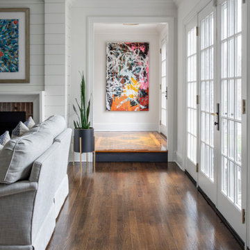 living room with modern graffiti art and custom chairs and millwork