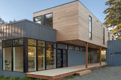 Small minimalist multicolored two-story mixed siding flat roof photo in Seattle