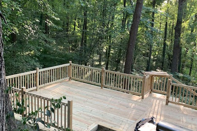 Deck - large rustic backyard ground level wood railing deck idea in Charlotte with no cover