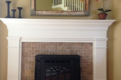 Trendy limestone floor living room photo in Manchester with beige walls, a standard fireplace and a stone fireplace