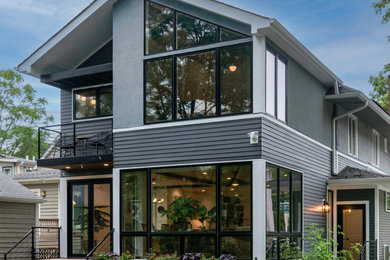 Mid-sized minimalist gray two-story concrete fiberboard and clapboard exterior home photo in Chicago