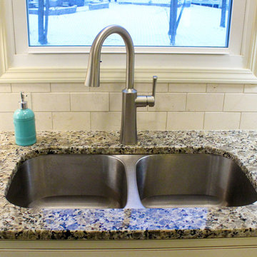 Beige Kitchen with Extra Large Island, Tile Backsplash and Granite Countertops