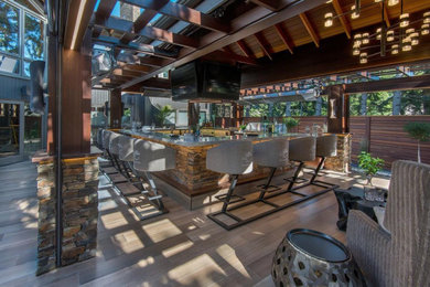 Large transitional backyard patio kitchen photo in Calgary with decking and a pergola