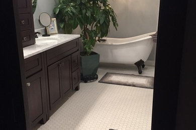 Freestanding bathtub - mid-sized coastal master porcelain tile and white floor freestanding bathtub idea in Other with furniture-like cabinets, brown cabinets, gray walls, an undermount sink and quartz countertops