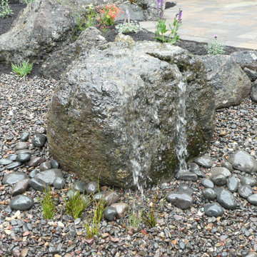 Bubbling boulder pondless water features
