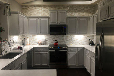 Mid-sized minimalist u-shaped kitchen pantry photo in Seattle with glass tile backsplash and no island