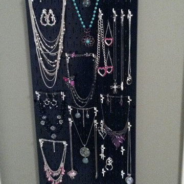 My metal pegboard jewelry organizer behind the door and utilizing a small wasted