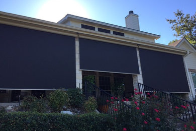 This is an example of a huge farmhouse concrete front porch design in Austin with a roof extension.