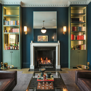 Exempel på ett modernt vardagsrum, med blå väggar, mellanmörkt trägolv, en standard öppen spis och brunt golv