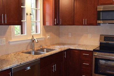 Mid-sized transitional u-shaped dark wood floor and brown floor kitchen photo in Milwaukee with an undermount sink, shaker cabinets, dark wood cabinets, granite countertops, beige backsplash, travertine backsplash, stainless steel appliances, no island and multicolored countertops