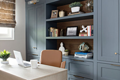 Example of a transitional home office design in Toronto