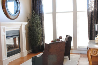 Living room - mid-sized transitional formal and open concept medium tone wood floor living room idea in Wichita with beige walls, a standard fireplace, a wood fireplace surround and no tv