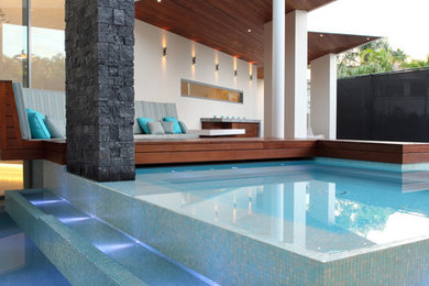 This is an example of a contemporary custom-shaped pool in Sunshine Coast.