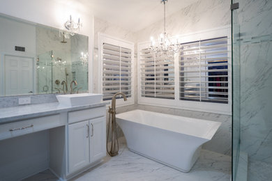 Huge transitional master white tile and porcelain tile porcelain tile, white floor and double-sink bathroom photo in Los Angeles with raised-panel cabinets, white cabinets, white walls, a vessel sink, marble countertops, a hinged shower door, white countertops and a built-in vanity