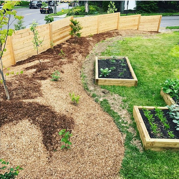 Cedar fence and berm shelter edible landscape