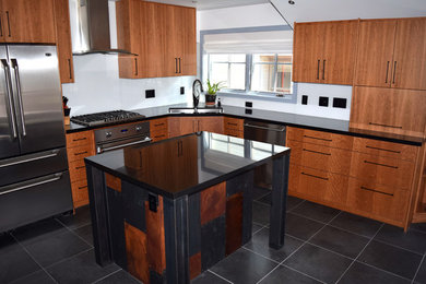 Example of a minimalist l-shaped black floor eat-in kitchen design in Denver with an undermount sink, flat-panel cabinets, medium tone wood cabinets, granite countertops, white backsplash, glass sheet backsplash, an island and stainless steel appliances