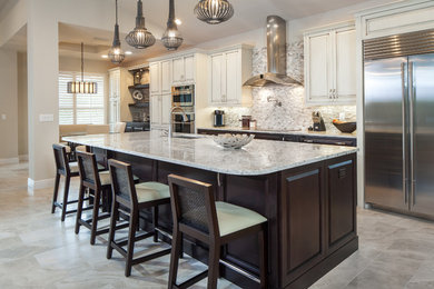 Inspiration for a mid-sized modern single-wall ceramic tile open concept kitchen remodel in Miami with raised-panel cabinets, distressed cabinets, granite countertops, multicolored backsplash, stone tile backsplash, stainless steel appliances, an island and an undermount sink