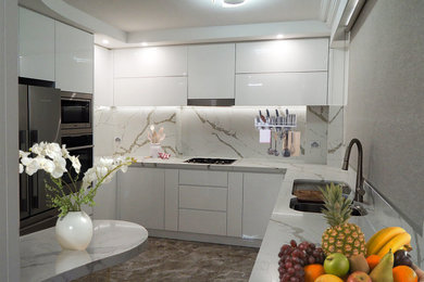 Design ideas for a mid-sized modern separate kitchen in Sydney with an undermount sink, white cabinets, solid surface benchtops, multi-coloured splashback, stone slab splashback, stainless steel appliances, porcelain floors, brown floor, multi-coloured benchtop and coffered.