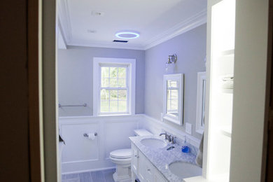 Tub/shower combo - small transitional kids' gray tile and porcelain tile porcelain tile tub/shower combo idea in New York with open cabinets, white cabinets, a one-piece toilet, green walls, an undermount sink and marble countertops