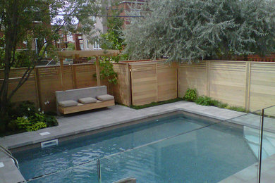 Pool - backyard concrete paver and rectangular natural pool idea in Montreal
