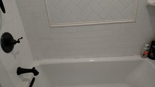 grout next to bathtub