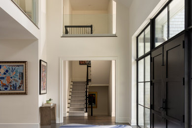 Mid-sized trendy dark wood floor and brown floor entryway photo in New York with beige walls and a black front door