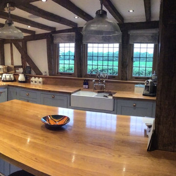 A charming, blue country kitchen installation with large island