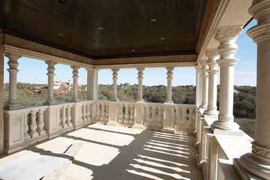 Example of a large tuscan backyard stone patio design in Dallas with a roof extension