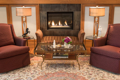 Photo of a mid-sized traditional formal open concept living room in Calgary with beige walls, light hardwood floors and a standard fireplace.