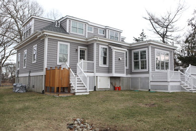 Inspiration for a mid-sized traditional grey exterior in Providence with vinyl siding and a hip roof.