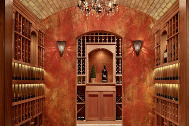This is an example of a large mediterranean wine cellar in Seattle with storage racks.