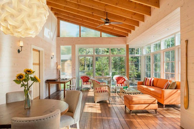 Inspiration for a large rustic medium tone wood floor and brown floor sunroom remodel in Other with a standard ceiling