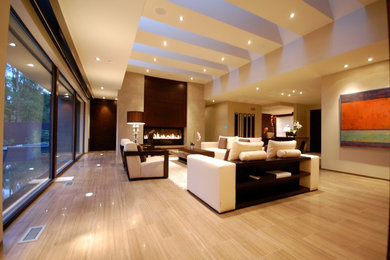 Inspiration for a large contemporary open concept porcelain tile and brown floor living room remodel in Toronto with beige walls, a ribbon fireplace and a tile fireplace